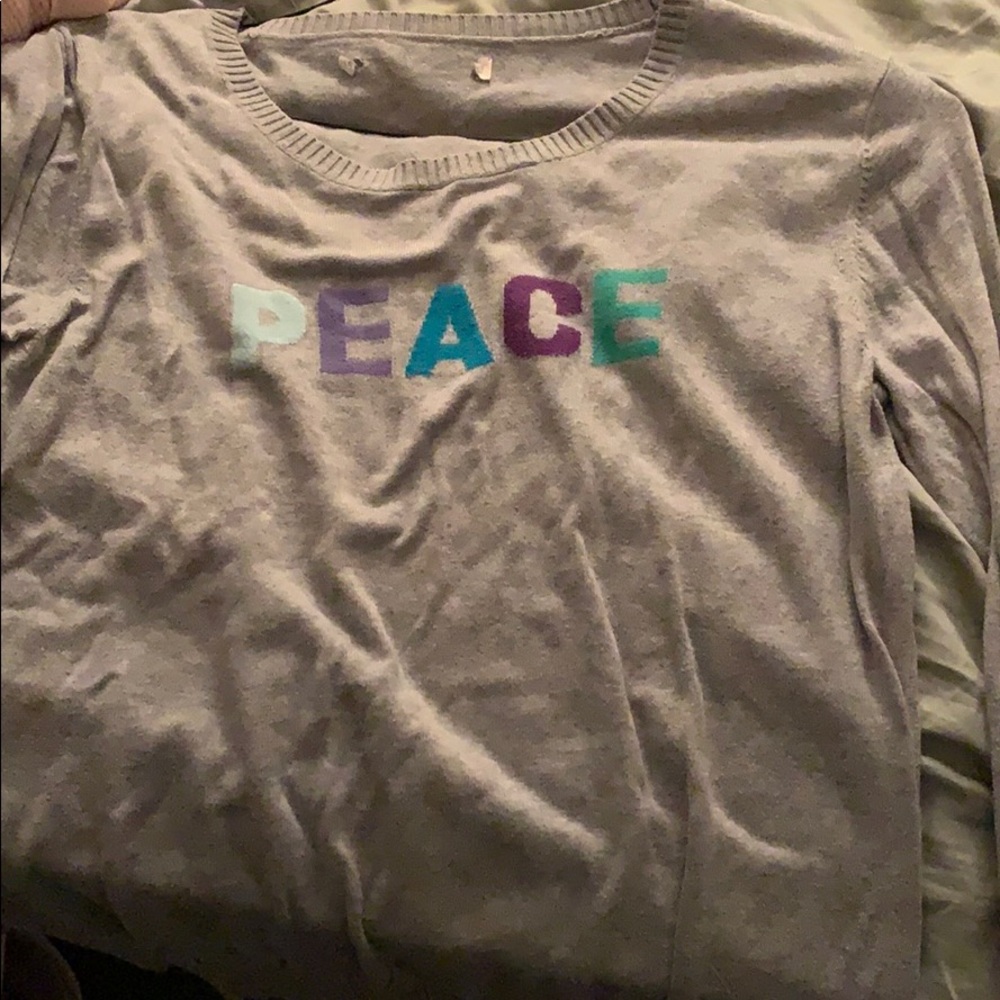 A thin sweater for spring saying “PEACE”